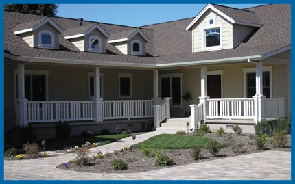 A house with a complex, well-crafted roof and porch area, showcasing the expertise of Sterling Roofing Co., Inc. in Glen Ellen.